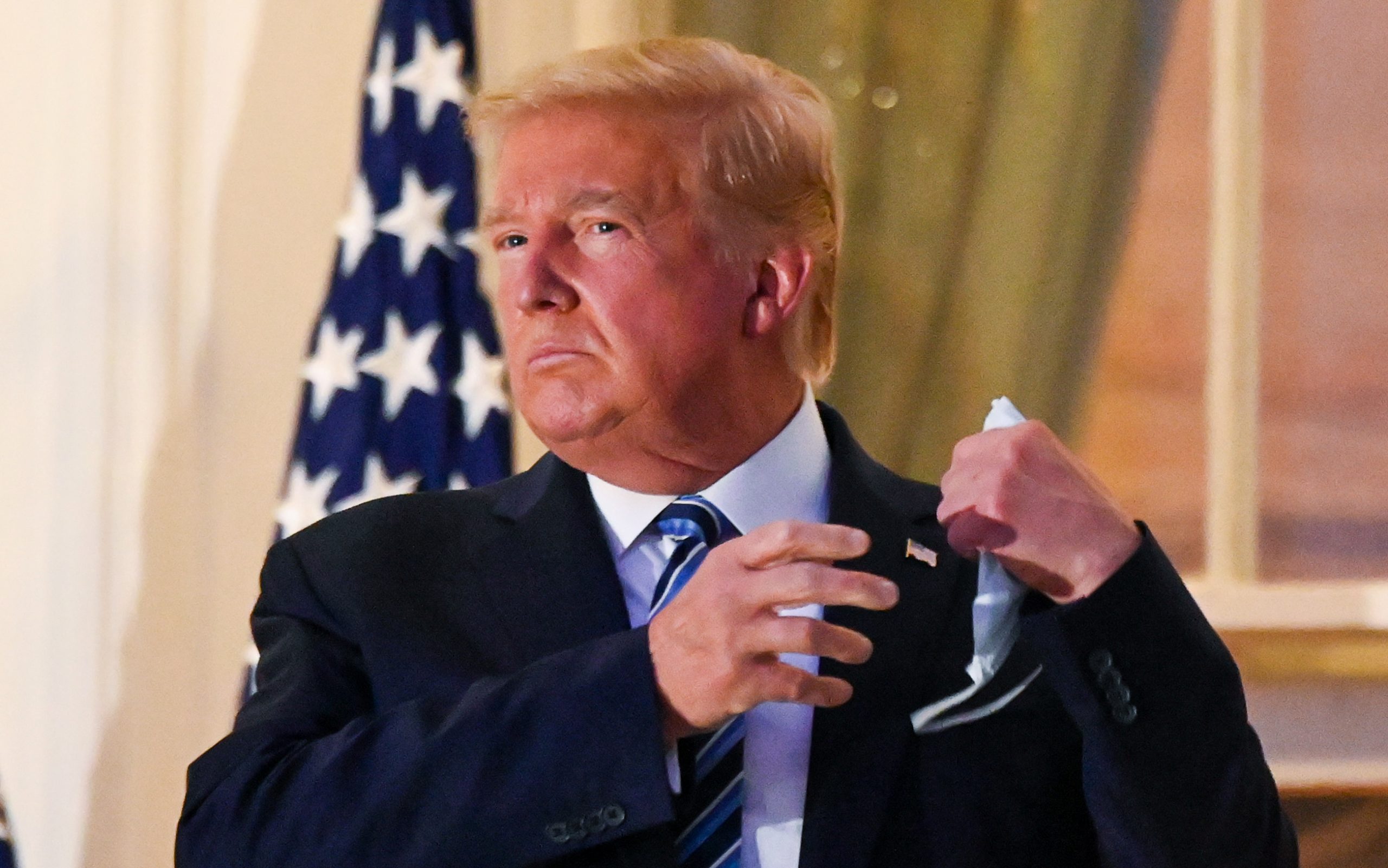 Trump Faces Backlash for Removing Mask on Return To White House