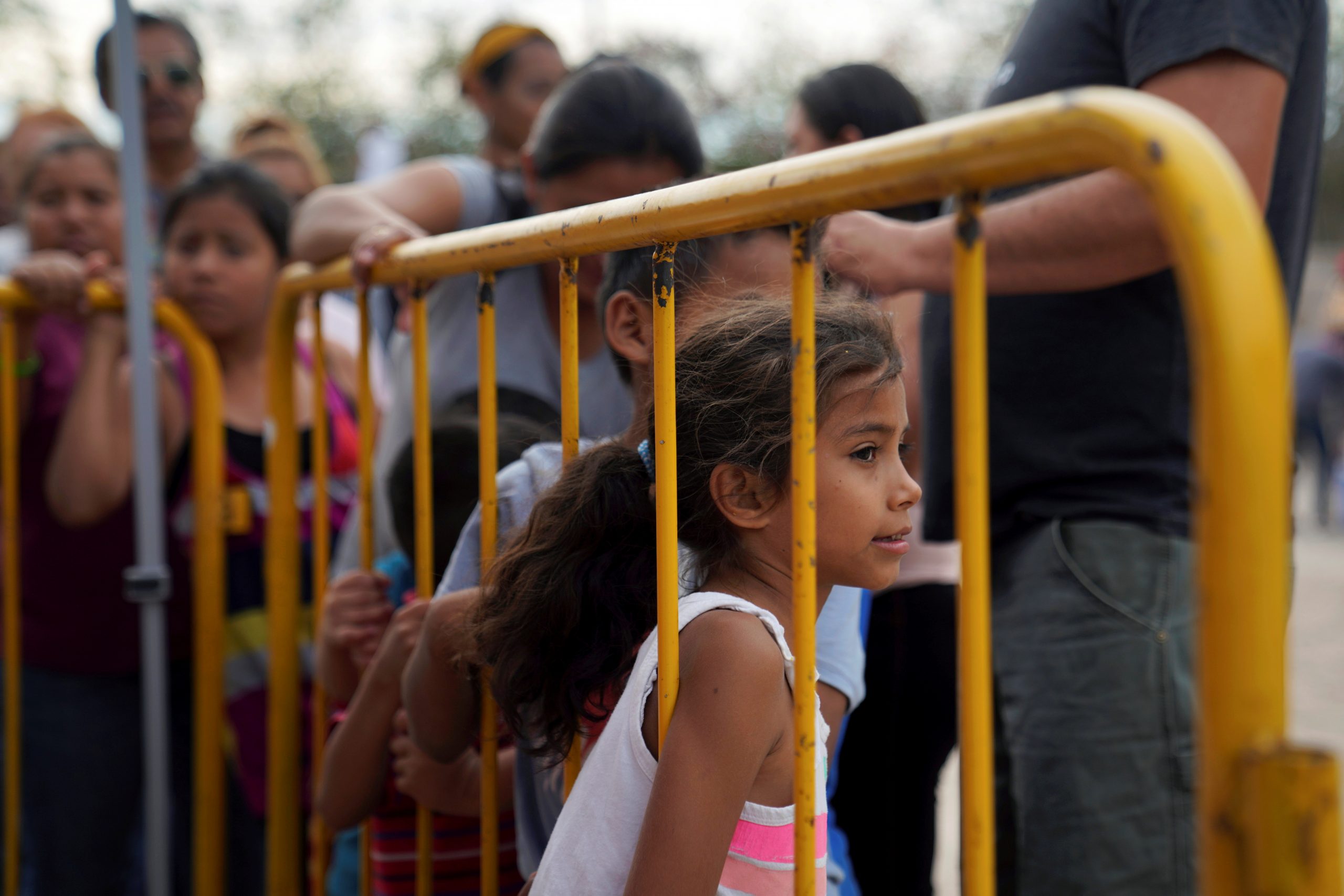 Numerous Migrants Photographed Wearing 'Biden, Let Us In' Shirts at Border
