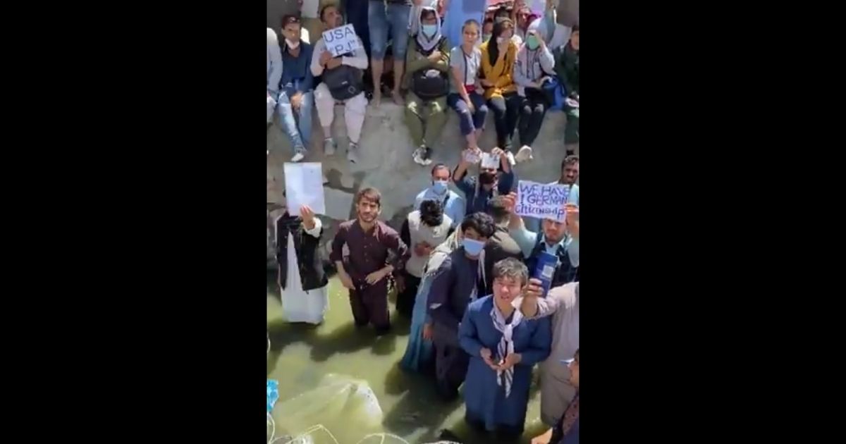 Biden’s Afghanistan: Shock Video Shows People Standing in Knee-Deep Sewage Begging to Be Let in Airport