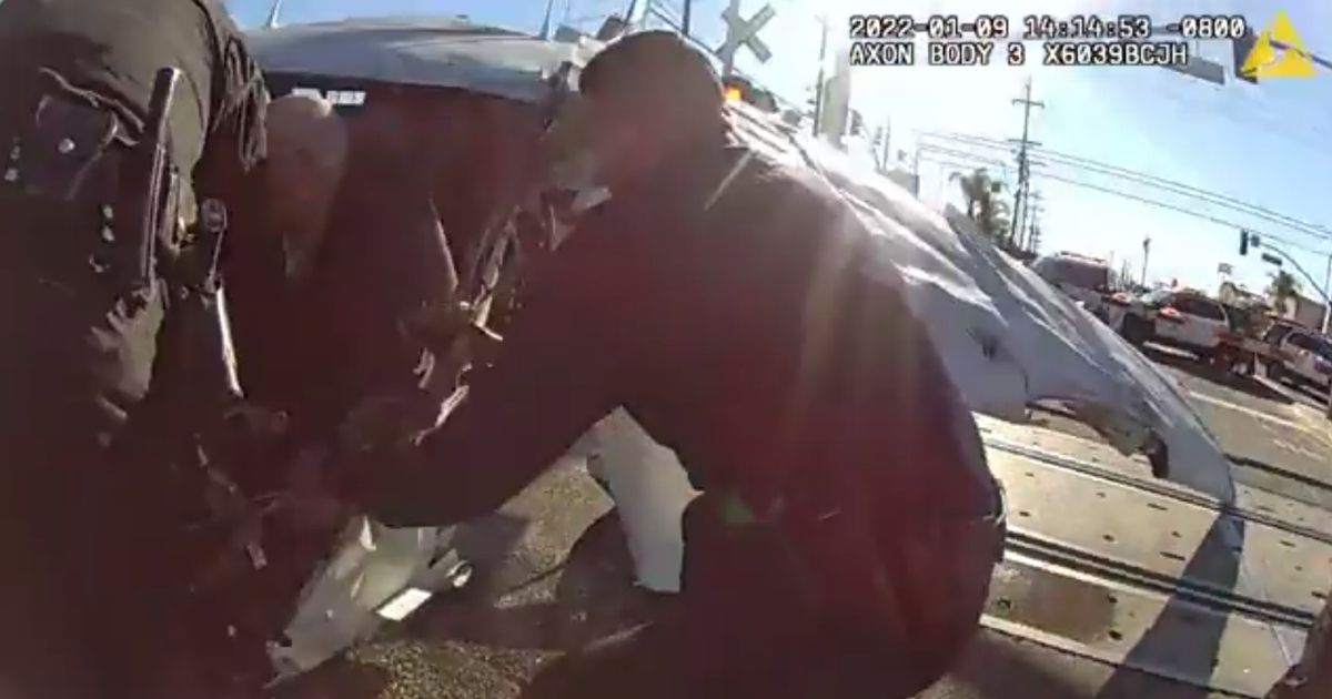 Video: Heroic Police Pull Crash Victim from Tracks 3 Seconds Before Train Obliterates Vehicle