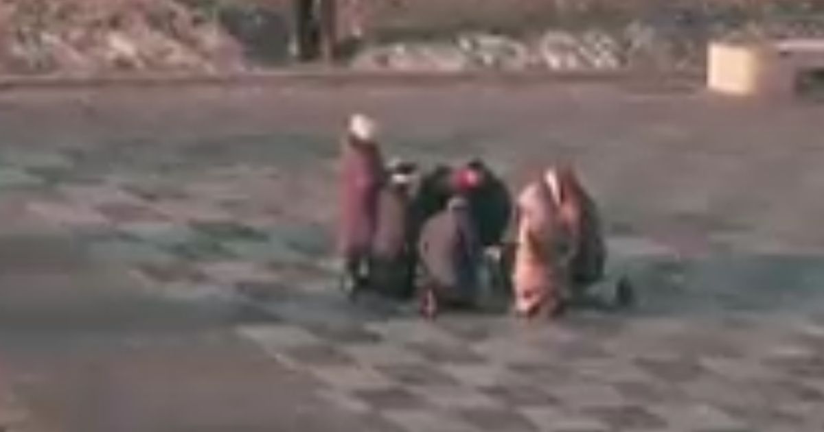 Watch: Ukrainians Kneel in Prayer on Street as Explosions Reported, Russia Invades