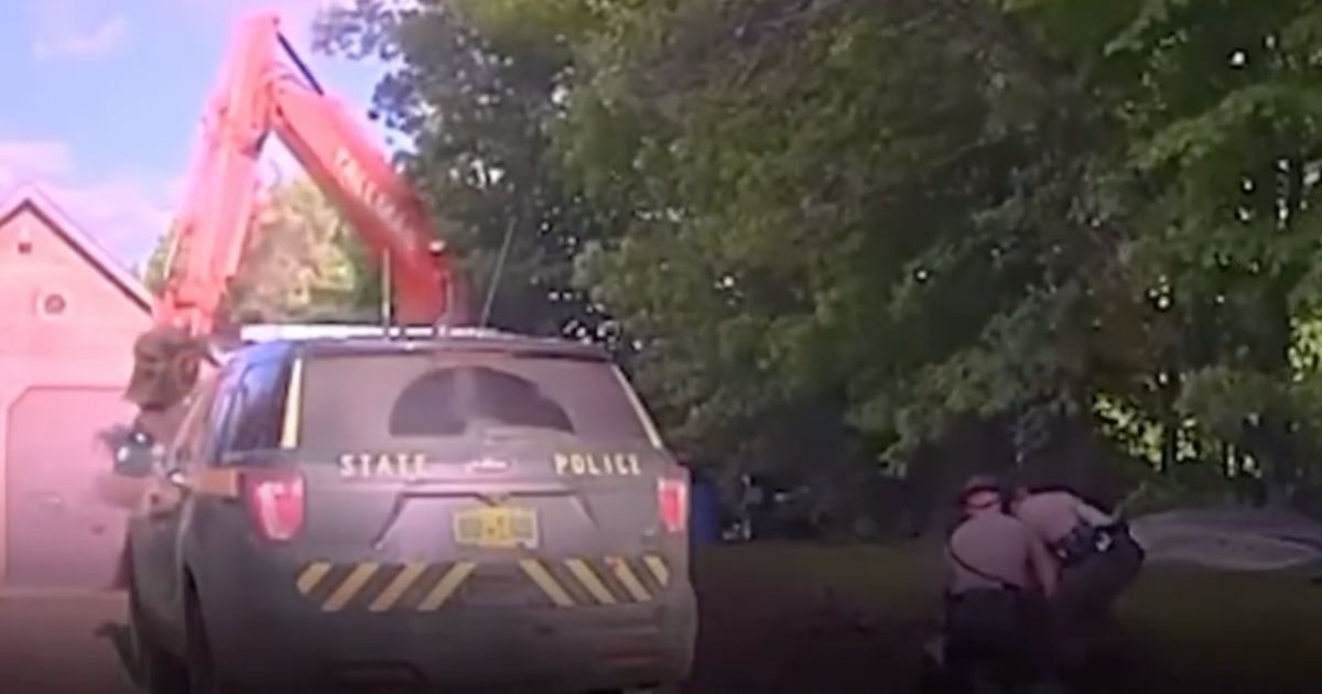 Troopers in Middle of Arrest Look Up to Find Out Suspect's Ally Is Now Coming at Them with an Excavator