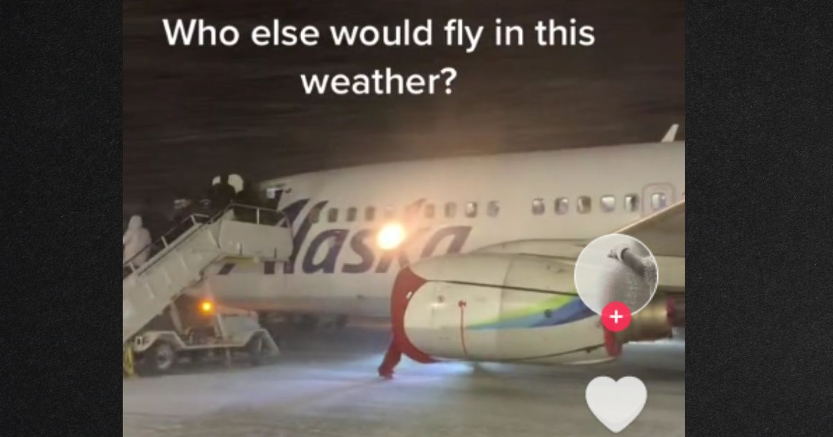Passengers bundled up to board the plane from the tarmac in a fierce, windy snowstorm.