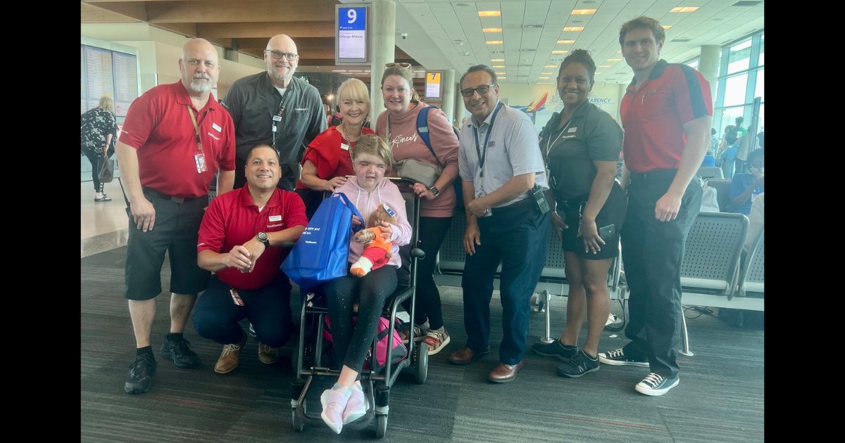 Southwest Airlines employees pose with Mary Cate Lynch.