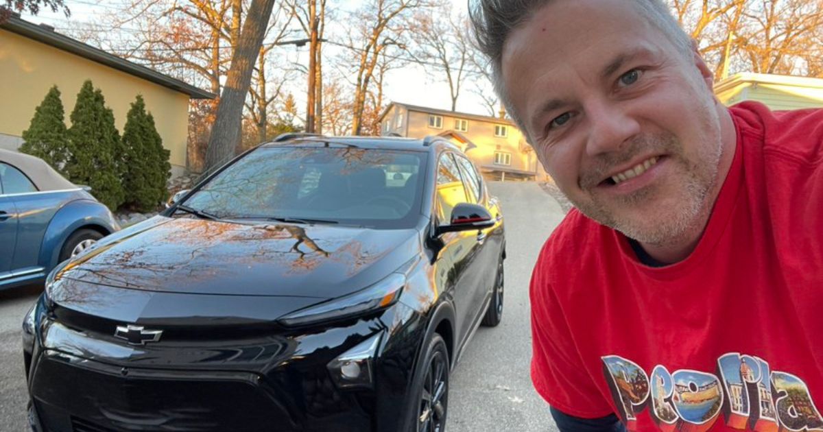 Congressman Eric Sorensen is seen with his EV.