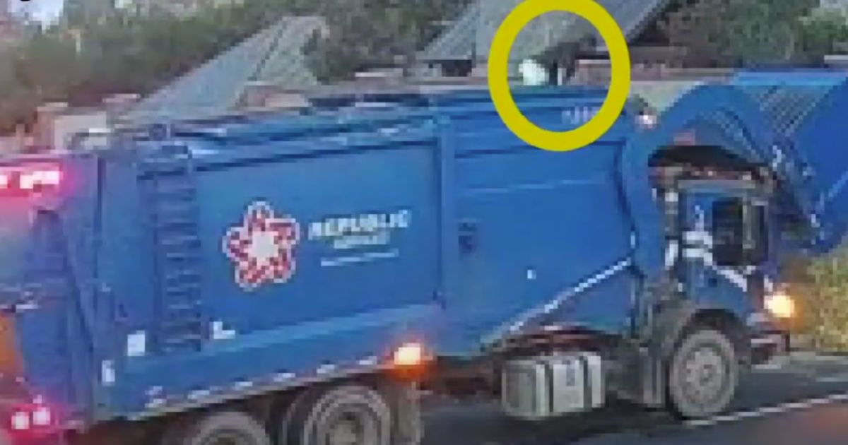 A man is rescued from a dump truck in this YouTube screen shot.