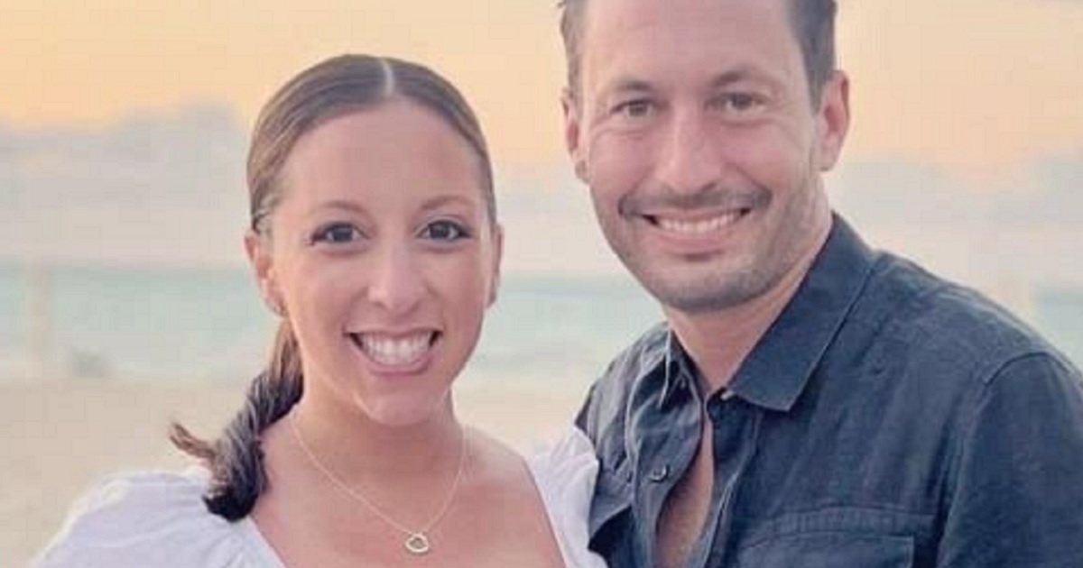 Veronica and Dax Tejero smiling in a beach photo.