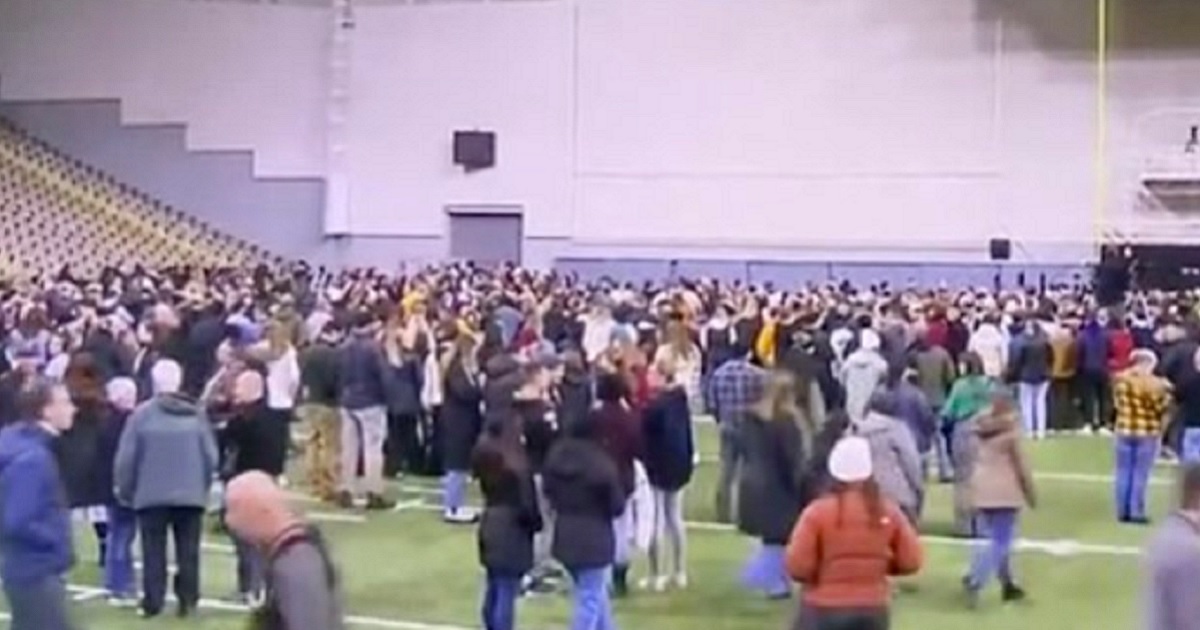 A scene from a November vigil for four slain University of Idaho students. Some Twitter users say the figure in the bottom left of the screen is murder suspect Bryan Kohberger.