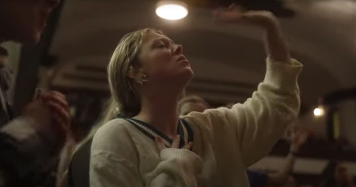 A young woman worships at the Asbury University revival in Wilmore, Kentucky, which has drawn people of all ages from miles around.