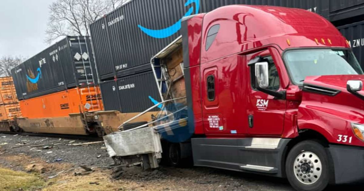 A police officer alerted the driver that a train was coming, so he exited the truck just before the crash.