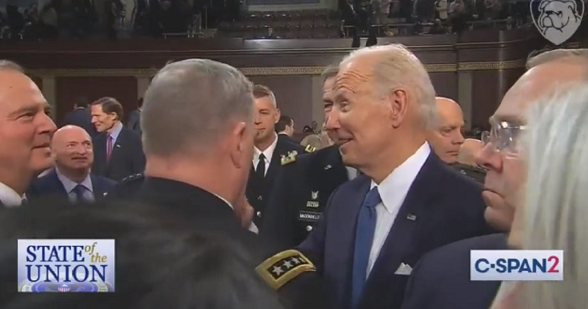 President Joe Biden pauses to speak to Demcratic lawmakers while leaving the House chamber after delivering the State of the Union address.