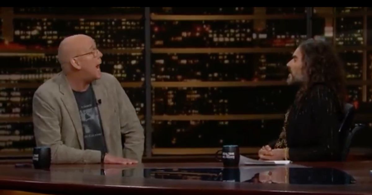 Comedian Russell Brand, right, speaks with MSNBC pundit John Heilemann.