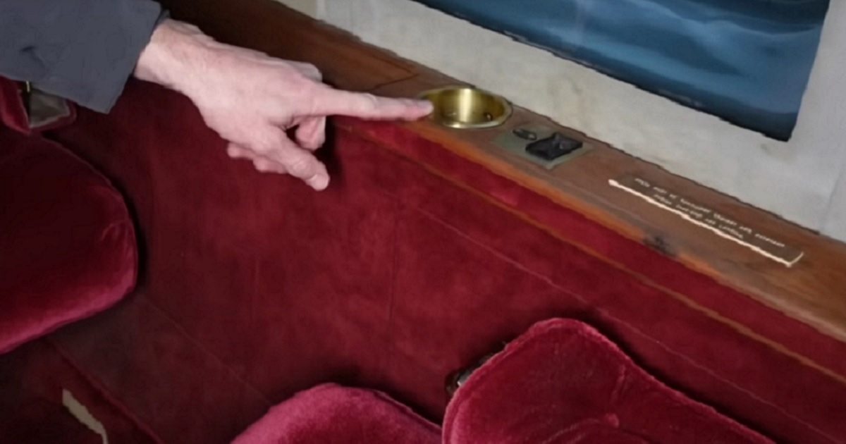 YouTube personality James Webb points to an ashtray on board a private jet once owned by superstar Elvis Presley.