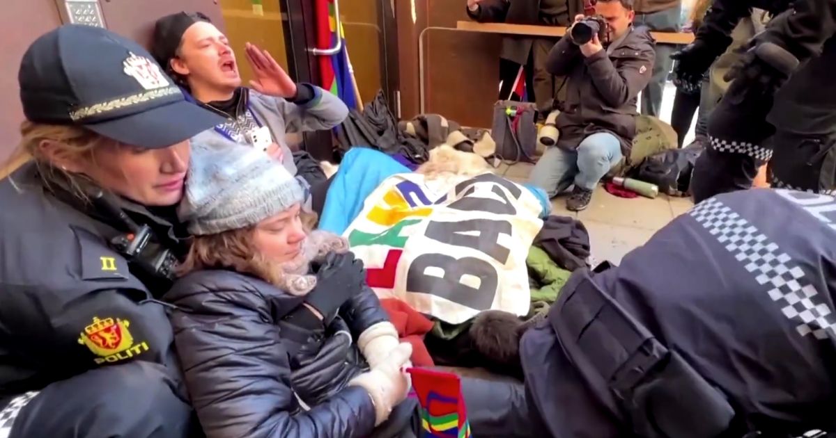 This Twitter video screen shot shows climate activist Greta Thunberg being removed from a government building entrance.