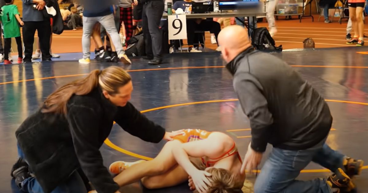 Adults attend to Cooper Corder after the 14-year-old was sucker punched after winning an April 8 match in Illinois.