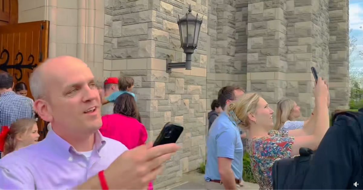 People looking at a rainbow at the Covenant School in Nashville