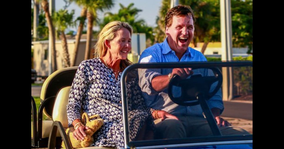 Tucker Carlson and his wife, Susan, ride in a golf cart near his Florida home.