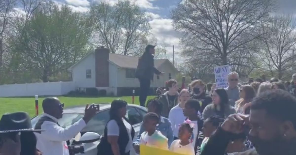 Protesters are seen in Kansas City, Missouri, on Sunday after a 16-year-old was shot.