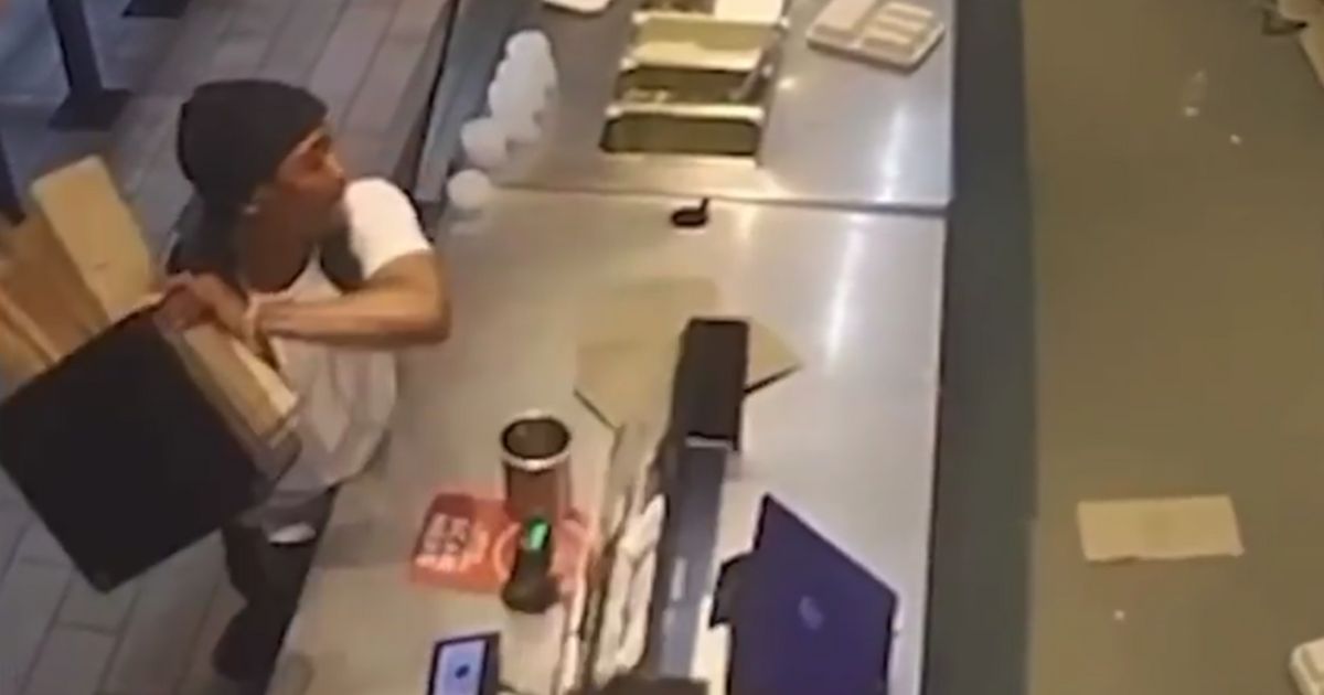 The man began grabbing items from the counter and hurling them into the employee work area.
