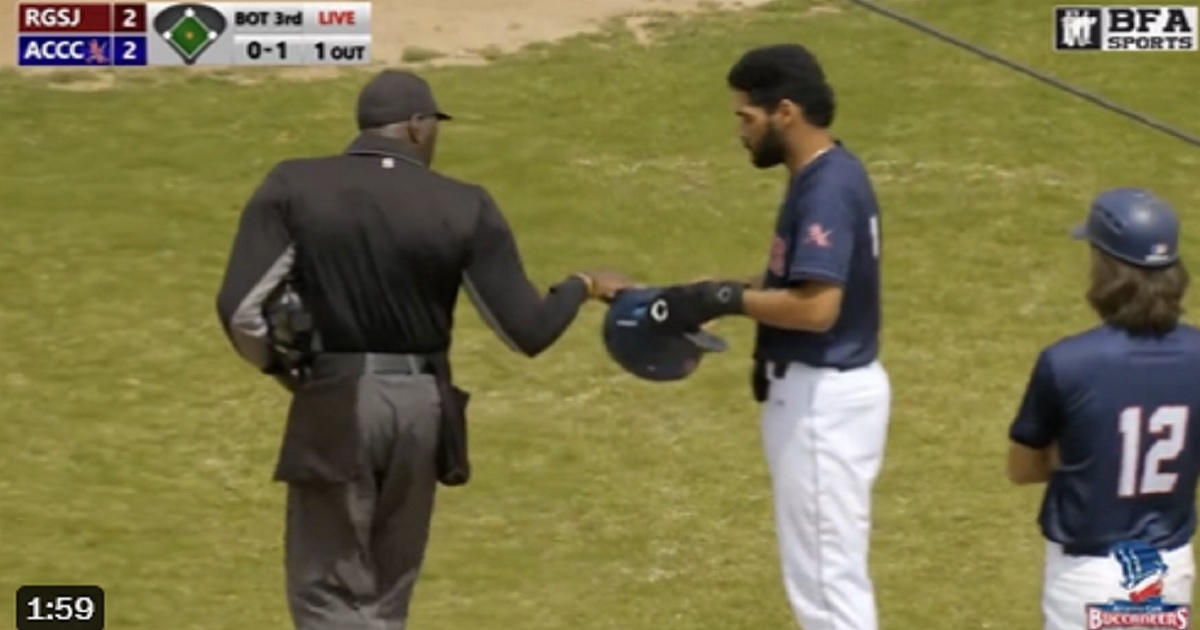 An umpire checks a player's helmet during an April 22 game between New Jersey's Atlantic County Community College and Rowan County Community College.