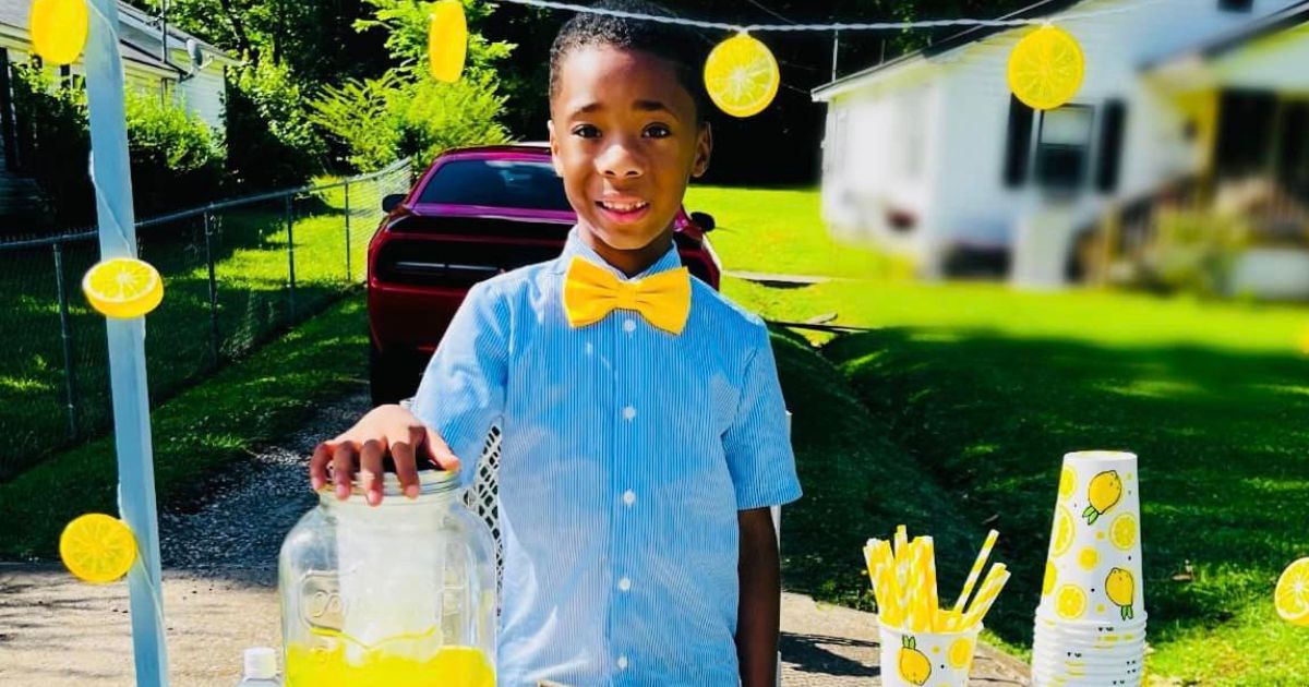 Cam Johnson poses with his lemonade stand.