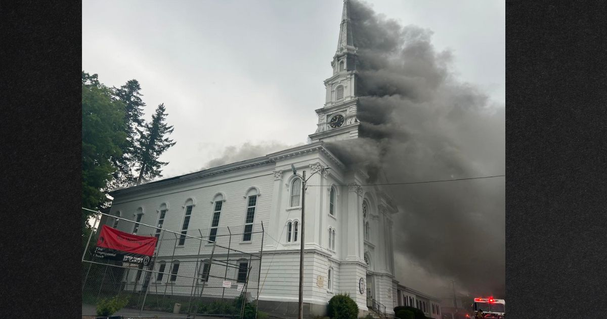 Smoke pours out of the historic First Congregational Church in Spencer, Massachusetts, Friday.