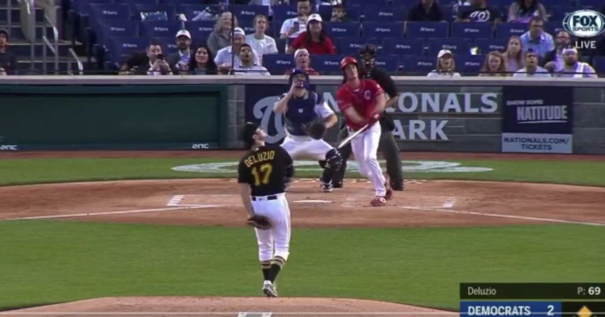 GOP Rep. Greg Steube, of Florida, hits a bases-loaded double against Rep. Chris Deluzio, a Democrat from Pennsylvania, during the third inning Wednesday of the Republicans' 16-6 rout of the Democrats in the annual Congressional Baseball Game, held at Nationals Park in Washington, D.C.