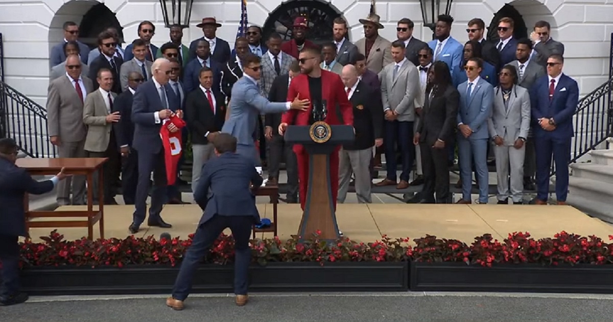Kansas City Chiefs tight end Travis Kelce stands at the podium Monday as quarter back Patrick Mahomes starts to usher him away from it during a White House event.