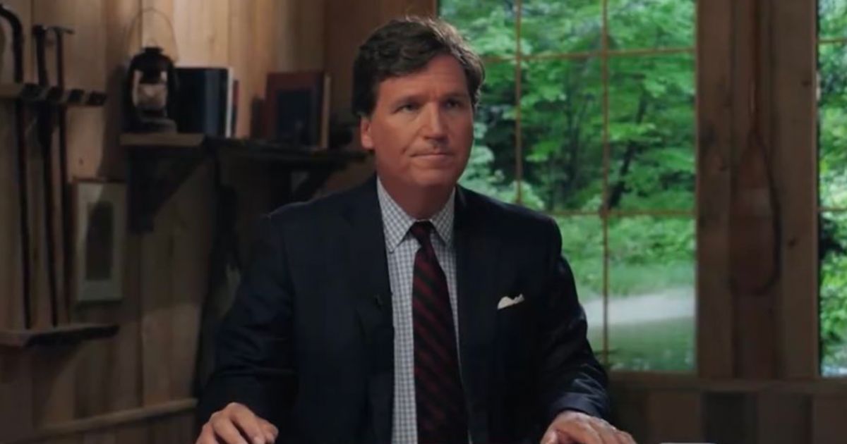 Tucker Carlson is seen at his news desk for his new show “Tucker on Twitter” in a Tuesday episode.