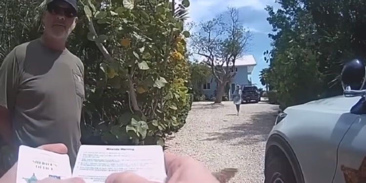 A New York man is interviewed by a Monroe County, Florida, deputy before his arrest on a charge of felony criminal mischief.