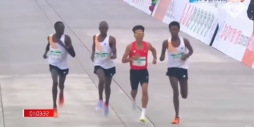 African runners appearing to slow down near the finish line to allow China's He Jie to overtake them