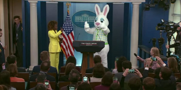 White House press secretary Karine Jean-Pierre with a character in a rabbit suit at the press room podium on Monday.