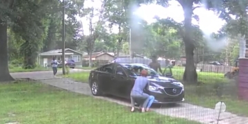 surveillance footage of two men attempting to steal a car from a family