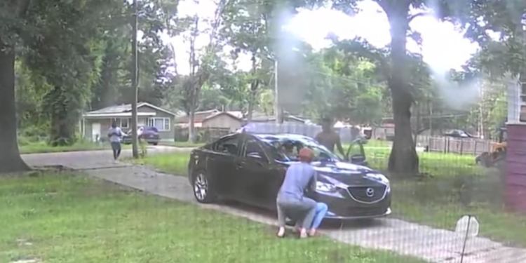 surveillance footage of two men attempting to steal a car from a family